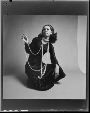 Woman modelling long string of beads