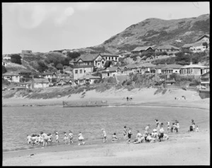 Island Bay, Wellington, with school children on the beach, and houses - Photograph taken by W Walker