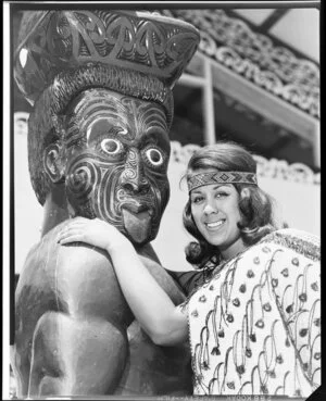 Unidentified Maori woman and pou, Te Puea Marae, Mangere, Auckland