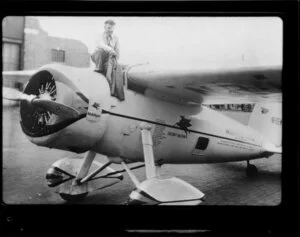 Man with eyepatch standing on Winnie Mae of Oklahoma (aircraft)