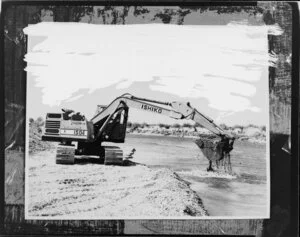 Digger, scooping gravel from river bed