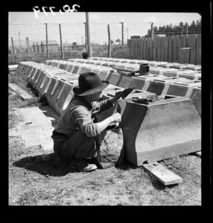 Japanese prisoner of war making chimneys for state houses at the camp near Featherston