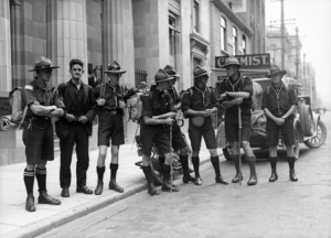 A group of boy scout leaders, dressed in uniform, standing on a Wellington Street