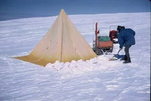 Shovelling snow around tent
