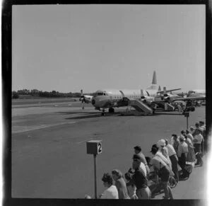 Crowd watching two Electra aeroplanes, Whenuapai
