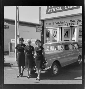 Three staff employees standing outside Mutual rental cars Ltd, Auckland