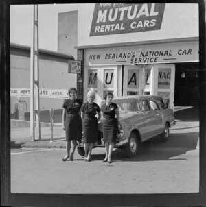 Three staff employees standing outside Mutual rental cars Ltd, Auckland