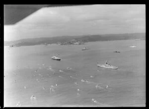 Royal Yacht Britannia with destroyer escort and submarine, Bay of Islands