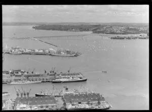 Auckland Harbour, with bridge, showing Royal Yacht Britannia and escort tied up