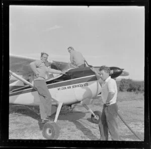 Don Middleton and two unidentified men with small aircraft, Mount Cook Air Services, Hokitika