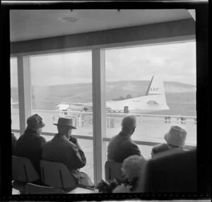 Passengers observing New Zealand National Airways Corporation aircraft on the tarmac, Dunedin Airport opening
