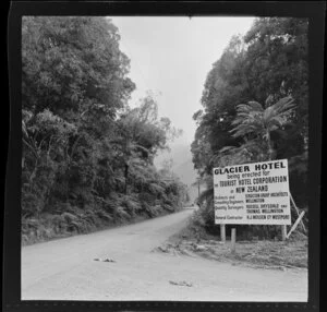 Sign for Glacier Hotel, being erected for Tourist Hotel Corportation of New Zealand, later Franz Joseph Hotel