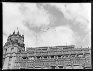 Biplanes from Whenuapai overflying in formation the Auckland Electric Power Board building, corner of Queen Street and Durham Street, Auckland