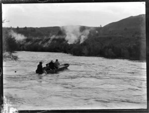 Four people in a skiff at Orakei Korako thermal area, Waikato River