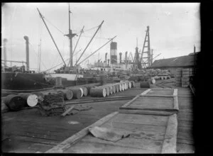 Chelsea Sugar Refinery, Birkenhead, Auckland, showing ship at wharf with rail wagons loaded with sacks of raw sugar alongside