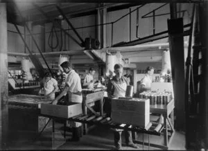 Chelsea Sugar Refinery, Birkenhead, Auckland, showing men packing tins of golden syrup