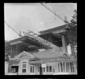 Construction of southern motorway viaduct, Newmarket, Auckland, including house used as site office