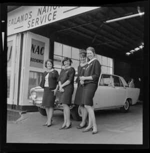 Four unidentified employees standing outside Mutual Rental Cars Ltd, Auckland