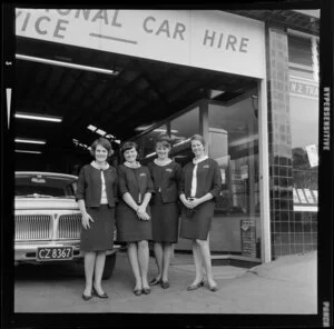Four unidentified employees standing outside Mutual Rental Cars Ltd, Auckland