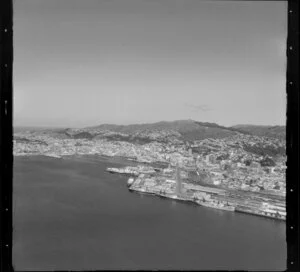 Wellington, city and harbour, featuring ships docked at wharves