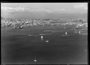 Power boat races on Waitemata Harbour, Auckland, including a view of the waterfront, wharves, and city buildings