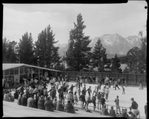 Crowd at skating rink, Queenstown with Lake Wakatipu and The Remarkables in the background