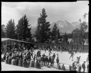 Crowd at skating rink, Queenstown with Lake Wakatipu and The Remarkables in the background