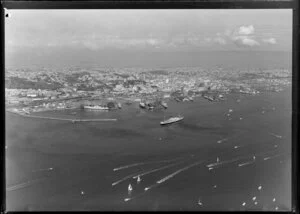 View across Waitemata Harbour, Auckland, showing waterfront, wharves and city buildings