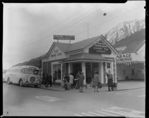 Tour bus, tourists outside Mount Cook Airlines office, Queenstown