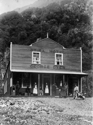 George Dyer's Otira Hotel, showing a group of people standing on and around the verandah