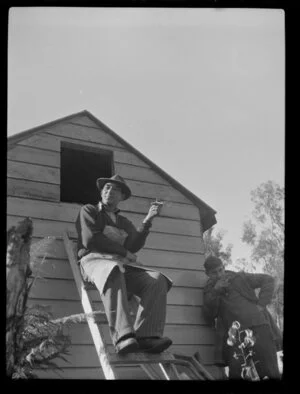 Fred Russell seated on a ladder at Fox Glacier, West Coast Region