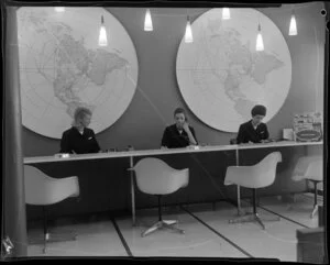Pan American World Airways office [Auckland?] including three unidentified female employees working behind customer service counter