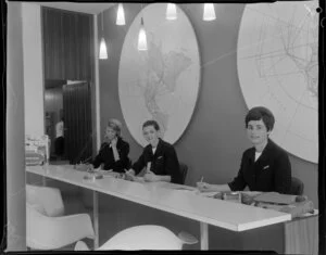 Unidentified staff members behind the customer service counter at Pan American World Airways office [Auckland?]