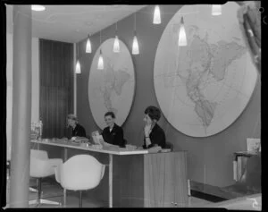 Unidentified staff members behind the customer service counter at Pan American World Airways office [Auckland?]
