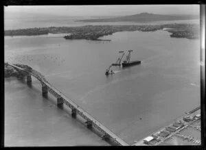 Auckland Harbour Bridge, including barge and cranes used in construction of bridge extensions