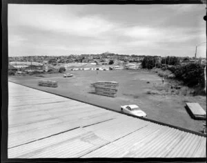Poultrymen's Co-Operative Penrose site with men surveying the site and the suburb in the background, Auckland