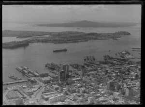 Auckland City and wharves, including Rangitoto Island in the background