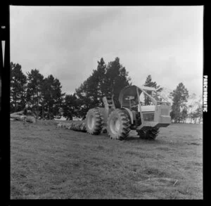 A demonstration of a tractor towing logs