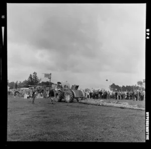 A demonstration of a tractor towing logs