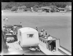 Cars and caravan being loaded onto the barge, Paihia