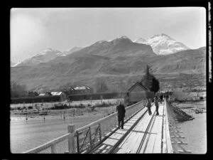 Unidentified group crossing the bridge, Glenorchy, including The Remarkables