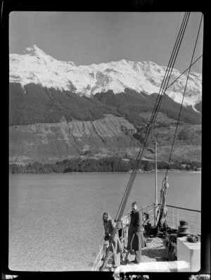 Unidentified man and woman on SS Earnslaw, including The Remarkables, Lake Wakatipu, Queenstown