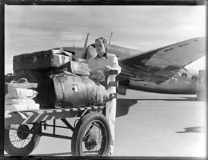 Unidentified man pushing luggage trolley, Harewood Airport, Christchurch