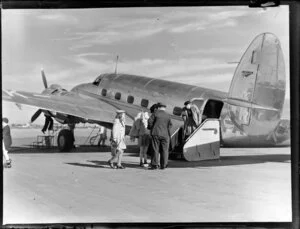 Group of people disembarking from aircraft, Harewood Airport, Christchurch