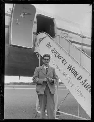 Mr Orbell standing outside the Pan American Airways aeroplane, Clipper Oriental