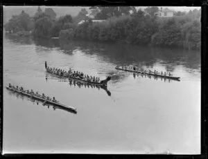 Three waka taua on the Waikato River [Royal visit?]