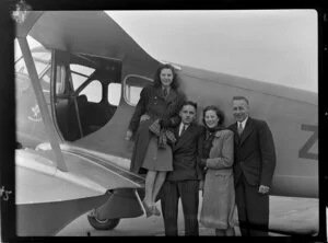 Unidentified passengers posing by a Canterbury Aero Club aeroplane