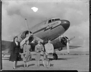 Four women standing in front of the Dakota aircraft Puweto, Milson Aerodrome, Palmerston North