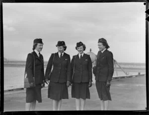 From left, P G MacCredie, L A O'Conner, P M Murray, S M Hoggard, stewardesses Tasman Empire Airways Ltd