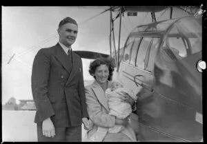 Mr and Mrs A W Bartlett and Jennifer (3 months) at Mangere after 20 hours flying from Dunedin in canopied Tiger Moth